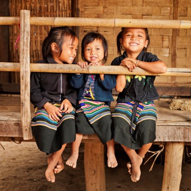 three-kids-sit-on-porch