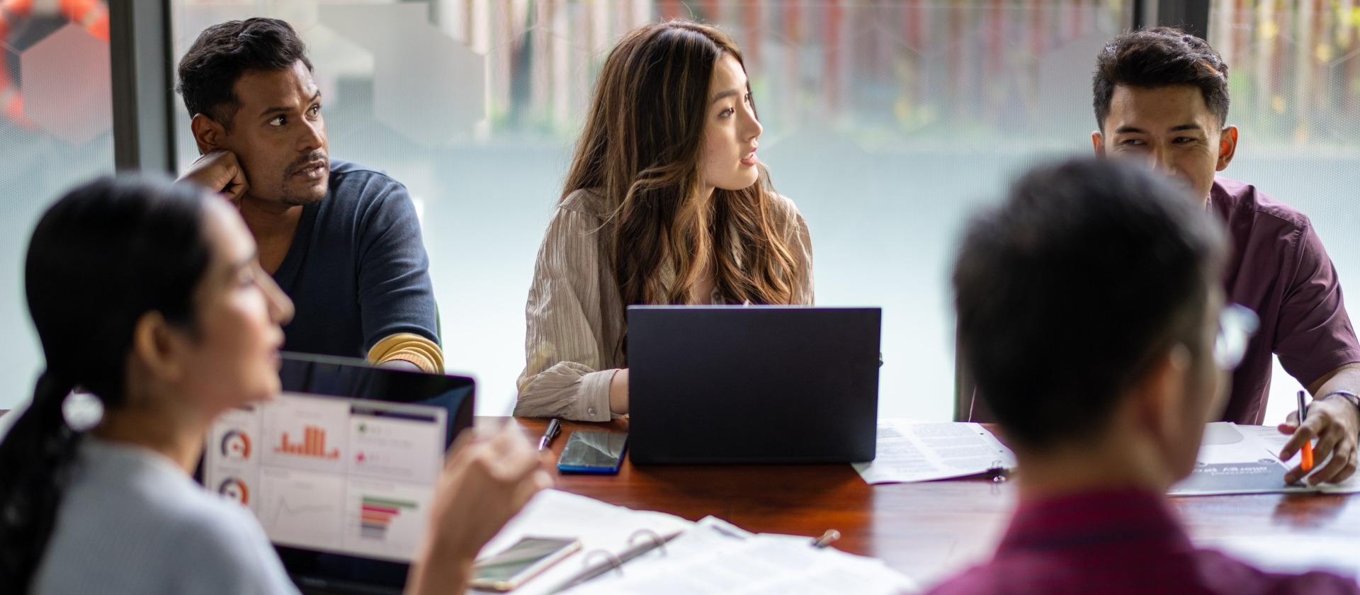 Group of people sitting around conference table