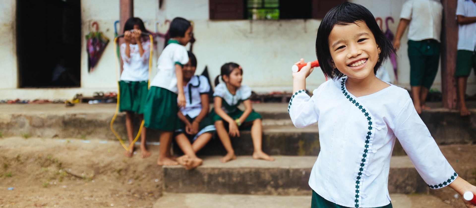 girl-smiles-outside-school