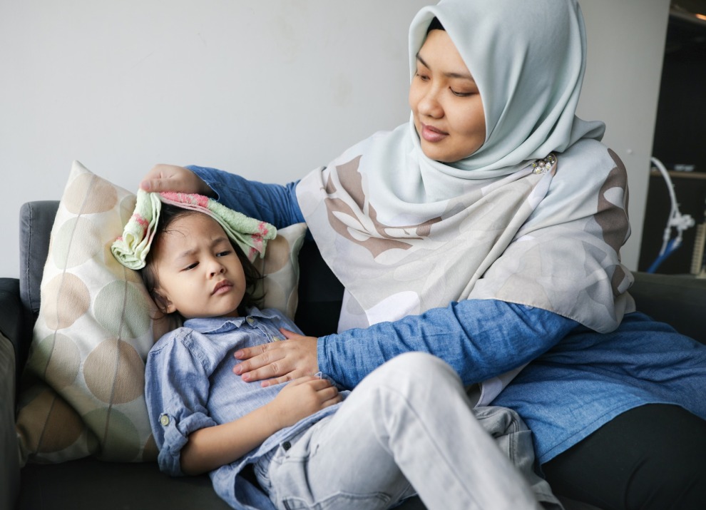 Mother comforting sick child