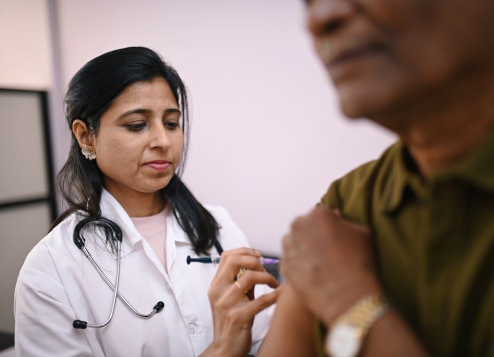 Doctor administering a vaccine.